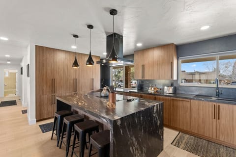 Cook, gather, and make memories in this stunning modern kitchen! With sleek wood cabinetry, a waterfall island, and top-notch appliances, this space is perfect for everything from morning coffee to gourmet meals.
