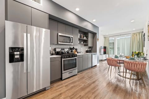 Gourmet kitchen equipped with premium stainless-steel appliances and a full-size refrigerator - perfect for home-style meals.