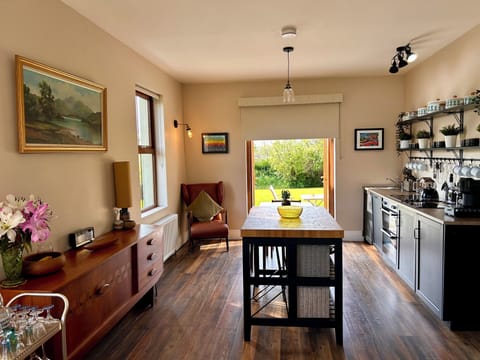 Kitchen/dining area seats 4 at table & 2 at centre island & opens out onto patio