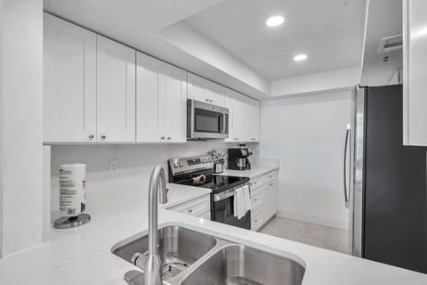Modern galley kitchen layout w/ ample counter space for easy meal prep.