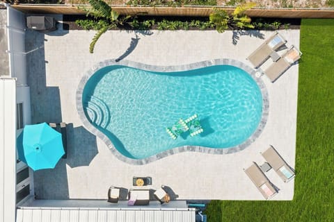 An Aerial view of the outdoors and its sparking pool. What a Paradise!