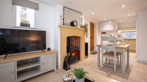 The open-plan living area of Crafty Cottage is a haven of warmth and whimsy.