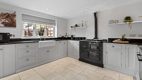 Both an AGA and electric oven/hob are on hand for preparing family meals