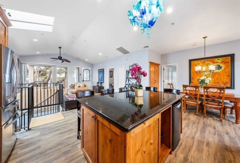 Inviting kitchen featuring rich wood cabinetry a spacious island with seating