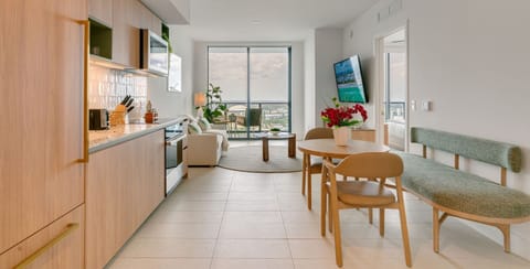Contemporary interior with smart TV, dining table, and green accents.