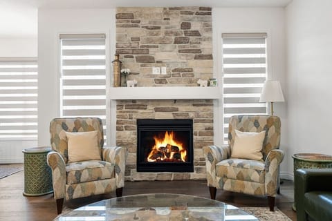 Main floor living room with an electric fireplace & cozy seating options.