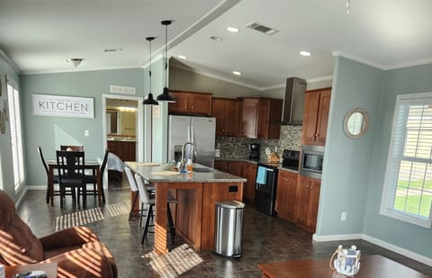 3-Bedroom House kitchen. Furniture and decorations may vary as we refresh the house on an ongoing basis.