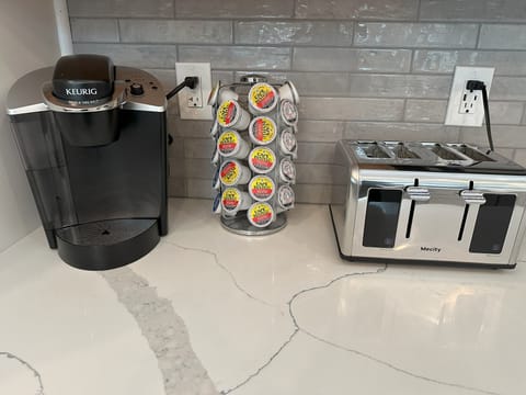 A Keurig machine, coffee and a toaster.