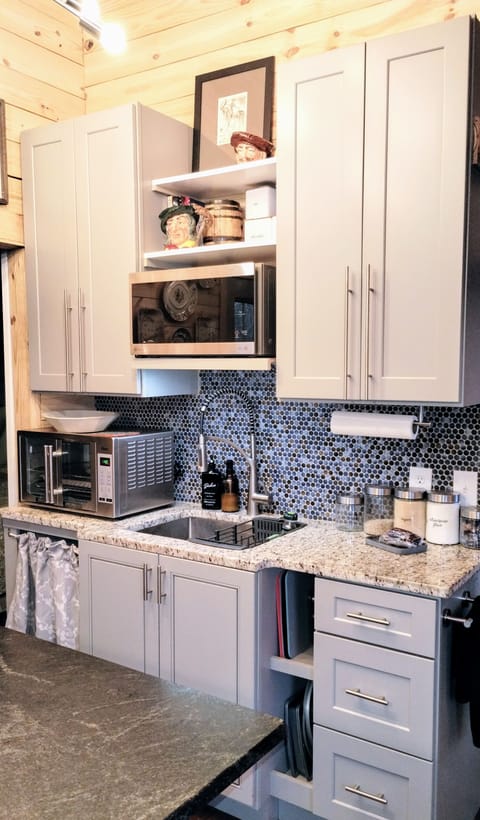 Efficiency Kitchenette w/ countertop oven, stone counters, microwave, cooktop