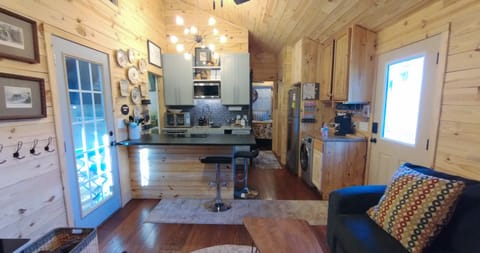 View of Kitchen/Guest BR from Living Room. Heart pine flooring throughout home