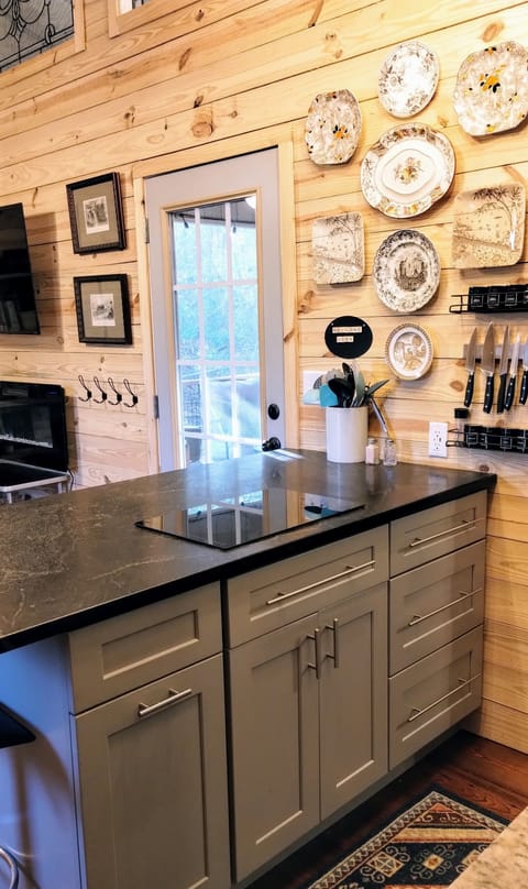 Two burner induction cooktop, eating bar seats four, custom cabinetry