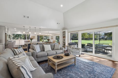 Spacious living room with beautiful golf course views and a flatscreen tv.