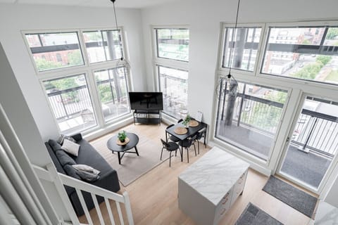 The high ceilings and large windows create a spacious atmosphere, perfect for relaxing after a day of exploring Tampere.