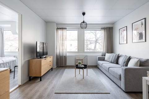 The living room connects to the dining area and open-plan kitchen.