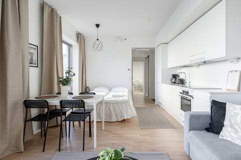 The spacious living room has a 140cm wide bed and an open kitchen and living area. The sofa is a 140 cm wide sofa bed.