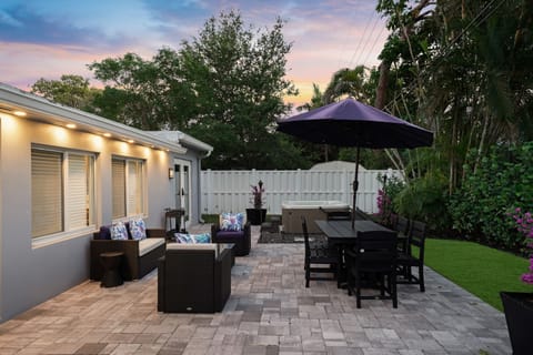 Enjoy outdoor dining and lounging in this stylish backyard with a spacious patio, comfortable seating, and ambient lighting. Ideal for morning coffee or evening gatherings.