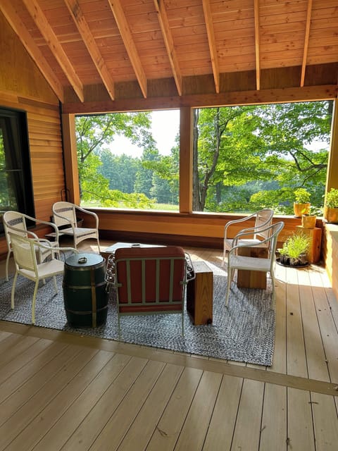 Generous three-seasoned porch, tucked back into the woods, mountain views