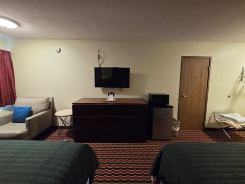 Basic Room, 2 Queen Beds, Bathtub Grab Bars | Living area | 35-inch flat-screen TV with cable channels