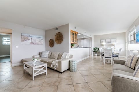 Thoughtfully designed open-concept living room with bay views, featuring a large smart TV and plenty of space to stretch out and unwind.