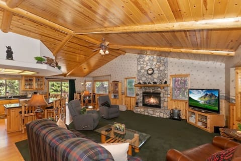 Relax in our rustic living room with a stone fireplace and comfortable seating