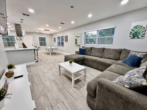 The open floor plan of the home creates a seamless connection between the living area, dining space, and kitchen.