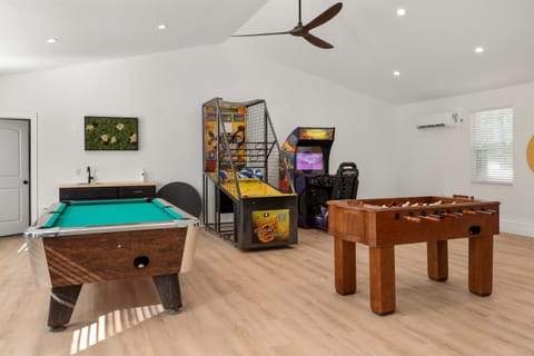 Shared game room at Notestone Reserve — separate building a short walk from Austen, pool table, arcade machines, and foosball included
