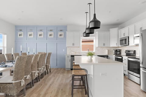- Host and toast with ease in this open concept kitchen featuring quartz counters and stainless steel appliances
- Spacious island seating and custom cabinetry blend style and function
- Gather around a spacious dining table set beneath soft lighting