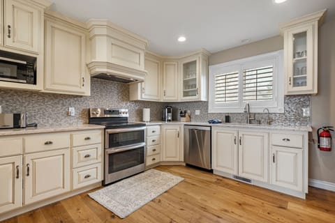 The Cottage kitchen has beautiful custom cabinetry, comes fully stocked with all major conveniences