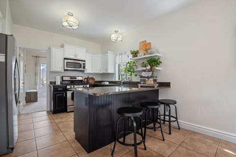 A large fully stocked kitchen right off the primary living room and dining room