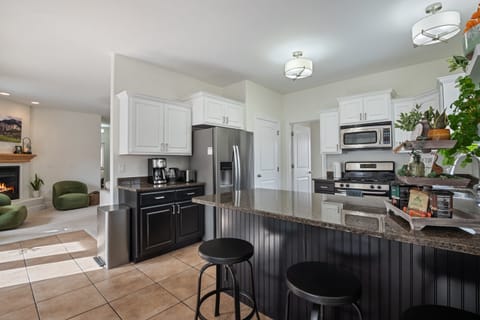 A large fully stocked kitchen right off the primary living room and dining room