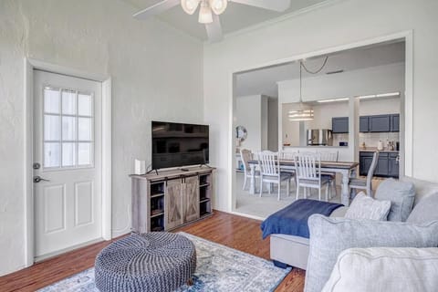 - Bright sunroom opens to dining and kitchen, creating the perfect entertaining space
- Cozy sectional, pouf ottoman, and flat screen TV invite easy lounging and fun
- Door leads directly to outdoor views, ideal for fresh air and sunset vibes