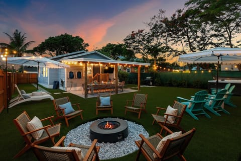 The spacious backyard is designed for fun and relaxation with a cozy firepit and a 6 person hot tub.