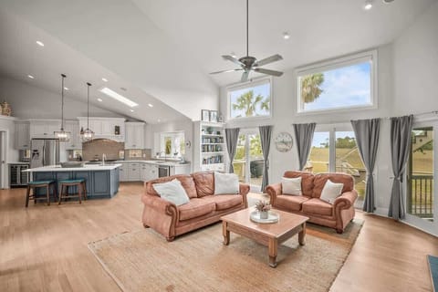 Open Concept Living Room with Access to Decks and Screened Porch with Marsh and Ocean Views