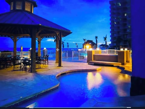 VIew across kiddy pool, thru usable gazebo & lg pool. Heated/indoor pool as well