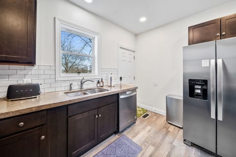 This bright and functional kitchen provides convenient outdoor access to the back porch which is off of the driveway.
