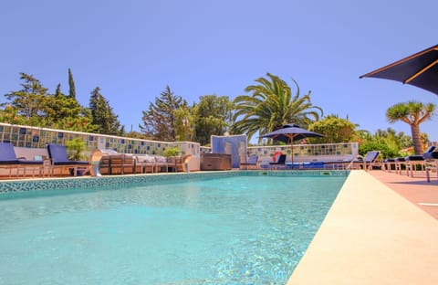 Spacious poolside area with sunbeds