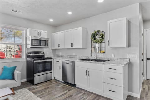 Full kitchen with refrigerator, microwave, dishwasher, stove/oven, coffee maker