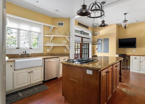 Bright gourmet kitchen with gas stove, ovens, granite countertops and plenty of space