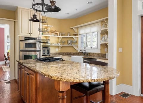 Bright gourmet kitchen with gas stove, ovens, granite countertops and plenty of space