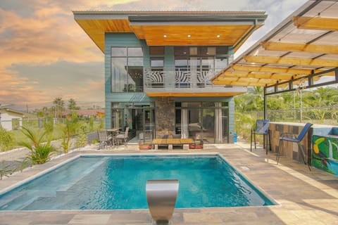 Front exterior of home with pool view