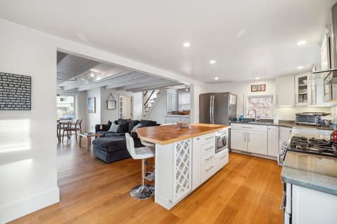 The fully equipped kitchen! This kitchen features a gas stove, seating for 4 at the island, a dishwasher and provided coffee! 