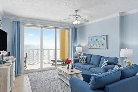Relax in style—cozy living room with a smart TV and direct balcony access for the perfect indoor-outdoor experience.