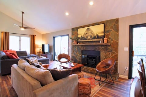 Welcome to Mountain Village 2005, your peaceful treetop retreat featuring a cozy stone fireplace and comfortable gathering space.