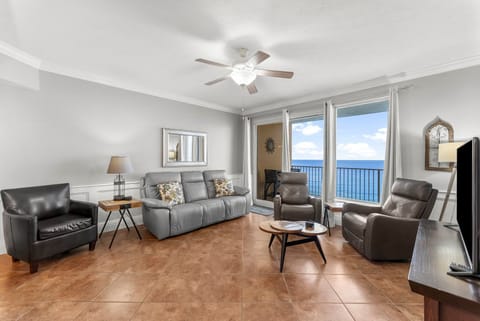 Relax in this modern living room with ocean views through large windows.
