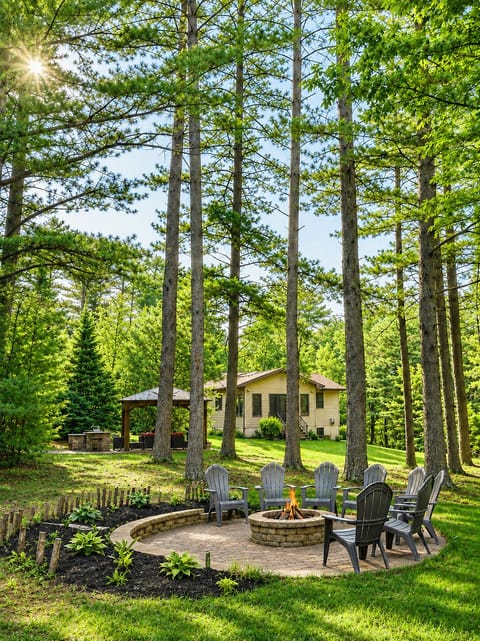 Secluded house, within 12 acres of forest, featuring outdoor firepit and gazebo.