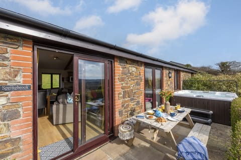 Patio area with picnic table and hot tub
