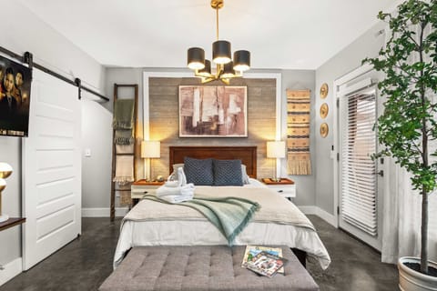 Bedroom with queen bed and framed art wall