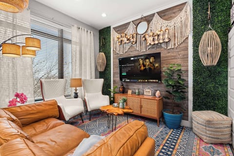 Boho living room with macrame wall art and greenery accent wall