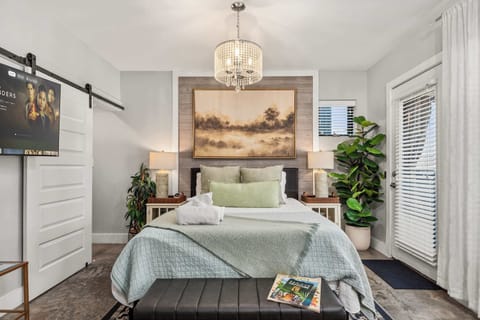 Bedroom with queen bed and framed wall art