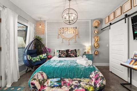 Bedroom with queen bed and colorful floral bedding
